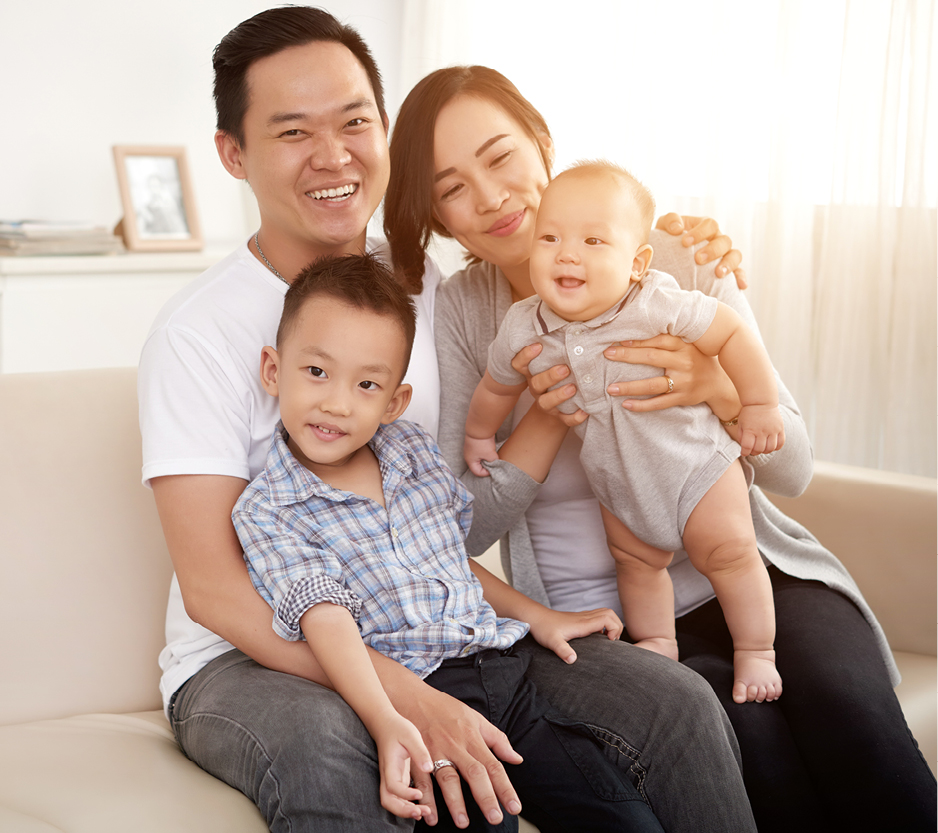 photo of parents holding their baby and young child