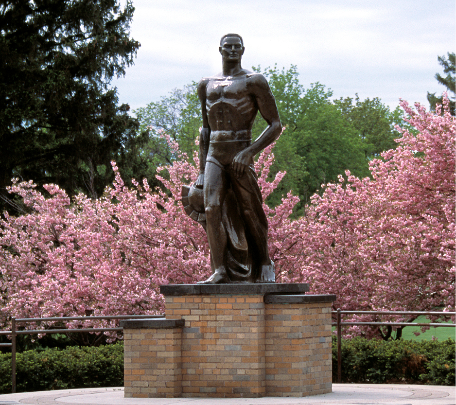 Sparty statue with flowers blooming around it.