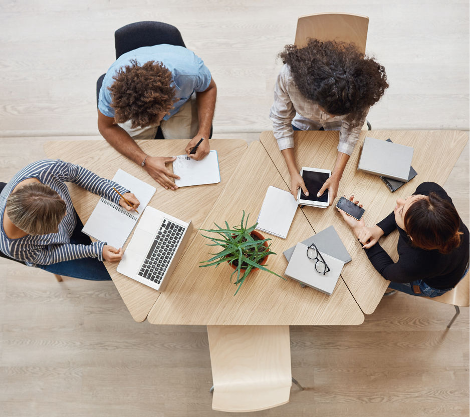 photo of a group of colleagues working together at a table.