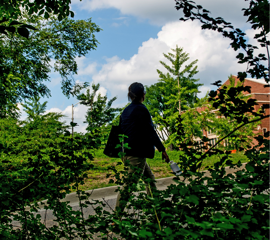 photo of a woman walking on campus.