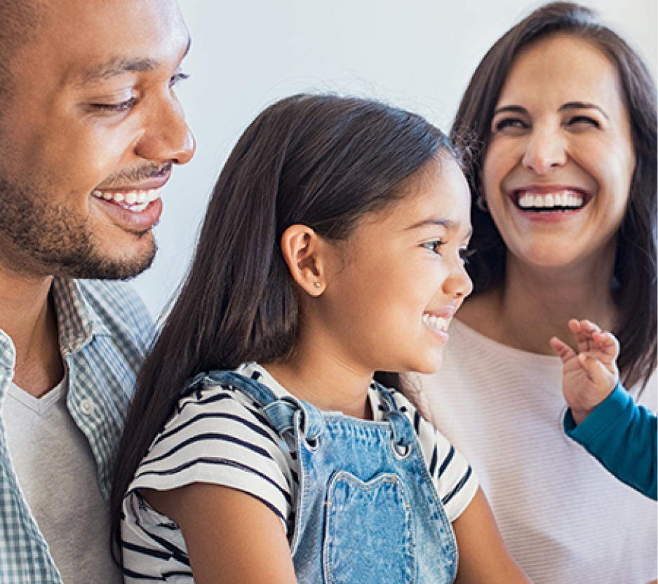 photo of a man and woman with their young child.